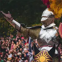 A mounted and armored knight, waving to a crowd